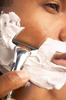 Close-up of man shaving