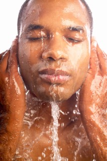 Close-up of man washing face