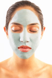 Studio shot of woman with blue facial mask