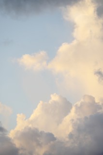 Soft white clouds against light sky