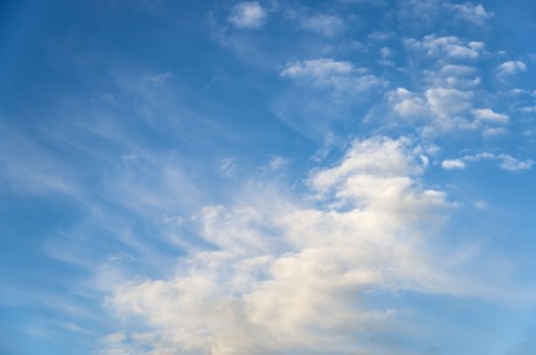 Blue sky with soft puffy clouds
