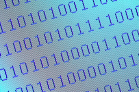 Close-up of pixelated binary numbers on computer screen