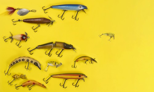 Retro fishing lures against yellow background