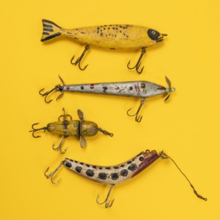 Retro fishing lures against yellow background