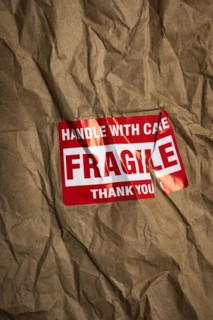 Fragile handle with care sticker on crushed package