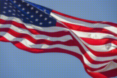Pixelated American flag waving against sky
