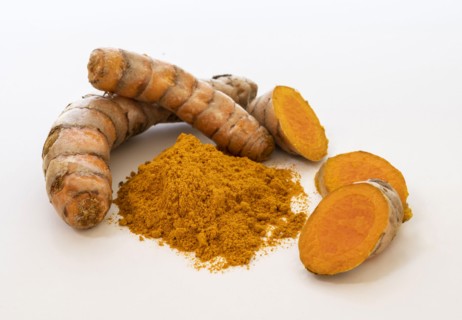 Turmeric powder and root on white background