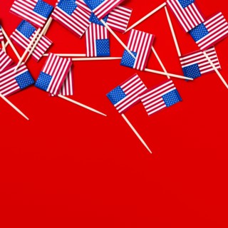 Small American flag toothpicks on red background