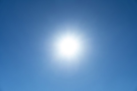 Bright sunburst in blue sky