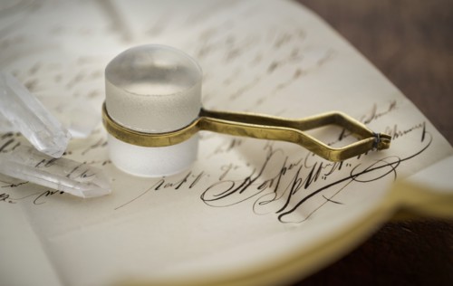 Stanhope magnifier with crystals on antique letter