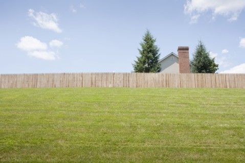Suburban house behind fence
