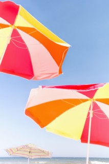 Beach umbrellas against blue sky