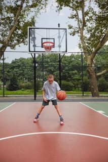 Boy playing basketball in park