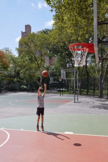 Boy playing basketball in park