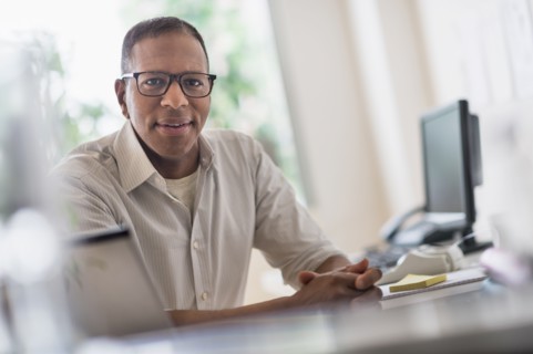 Portrait of smiling mature man working in home office
