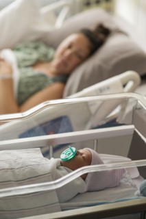 Mother lying with newborn baby girl
