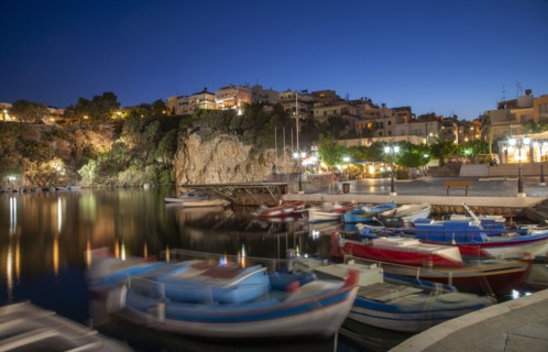 Boats in harbor and village on cliffs