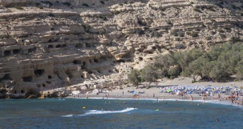 Tourists lying on beach and bathing in sea