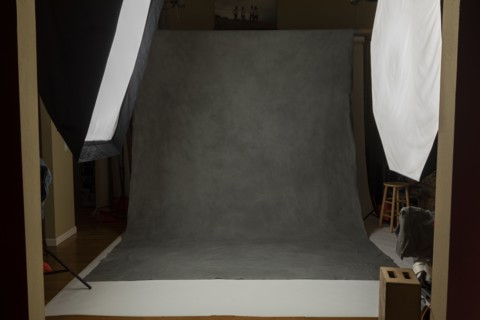 Photo studio set with lightboxes and painted muslin background