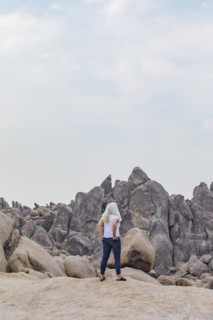 Woman looking at Alabama Hills rock formations