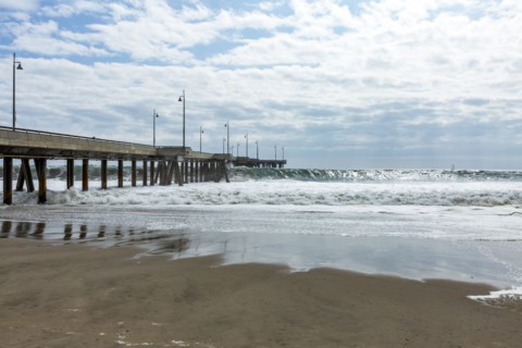 Waves cresting under pier