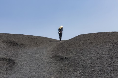 Woman hiking in cinder cone at Craters of the Moon National Monument