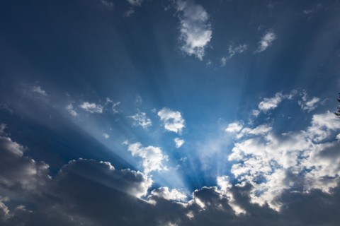 Rays of sunlight between clouds