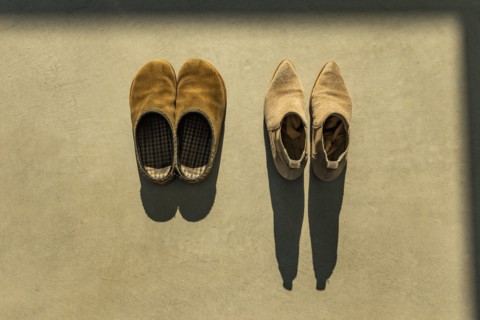 Two pairs of shoes lit by early morning sun