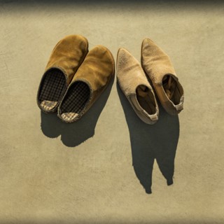 Two pairs of shoes lit by early morning sun