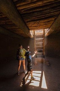 Boy and girl exploring Native American kiva