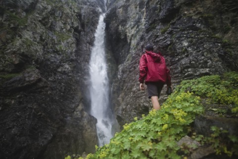 Hiker standing near waterfall