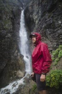 Hiker standing near waterfall