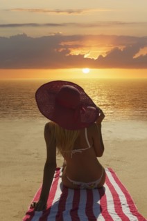 Caucasian woman admiring sunset on beach