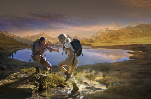 Caucasian hikers walking near remote lake