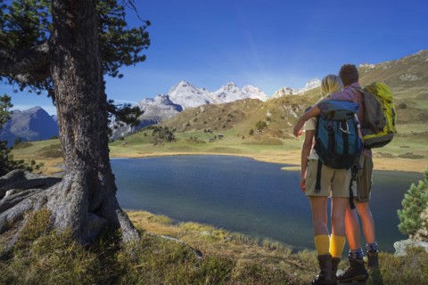 Caucasian hikers admiring remote lake