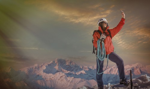 Caucasian hiker taking selfie on mountaintop