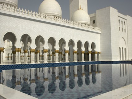 Ornate colonnade reflecting in still pool