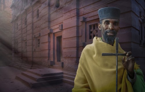 Black priest carrying cross in Lalibela