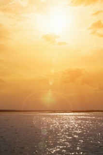 Sunset over rippling ocean water