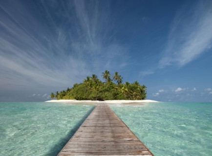 Wooden dock walkway to tropical island