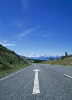 Directional arrow on empty remote road