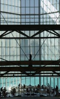 People in modern glass atrium
