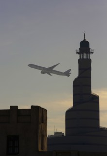 Airplane flying over Doha cityscape