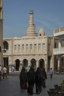 Women in hijab walking in Doha square