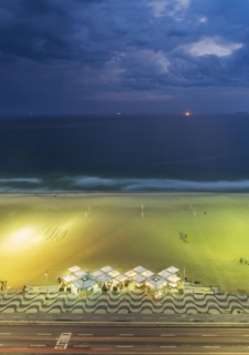 Aerial view of market on beach under cloudy sky