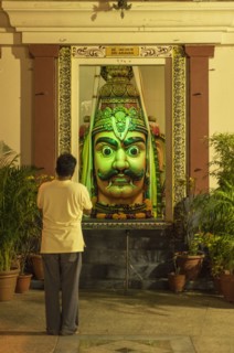 Man admiring statue in ornate temple