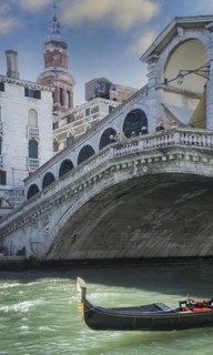Empty gondola sailing on Venice canal