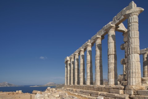 Temple of Poseidon ruins under blue sky