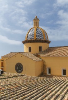 Church dome and roof under cloudy sky