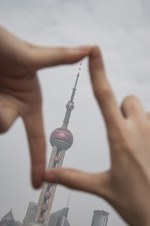 Chinese woman framing Shanghai tower